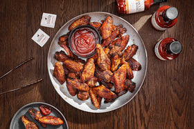 Fiorella's Jack Stack sauce with sizzling meat dish, ready to elevate.