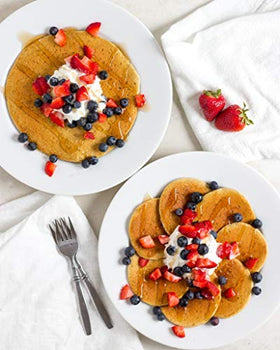 Stack of FlapJacked pancakes with syrup and butter, ready to enjoy