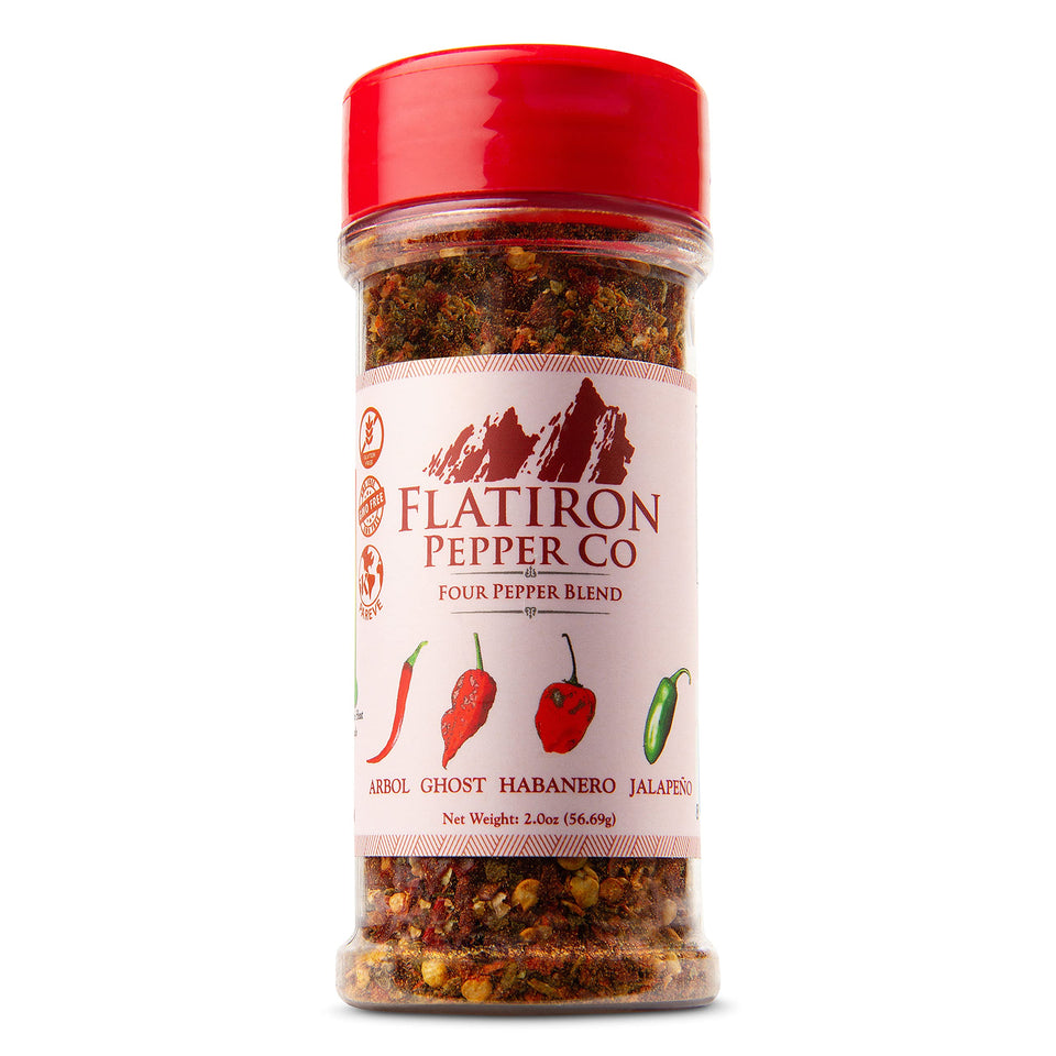 Flatiron Spice Four Pepper Blend bottle on kitchen counter adds bold flavor.