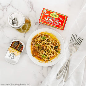 Flower Brand wild sardines in tomato sauce, open can showing glossy fillets
