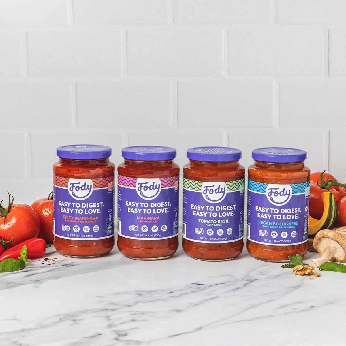 Family dinner with bowls of pasta and Fody marinara sauce.