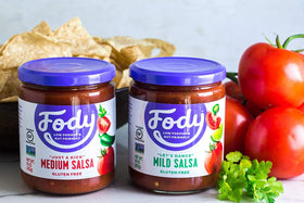 Fody Mild Salsa glass jar on counter, convenient pantry staple.