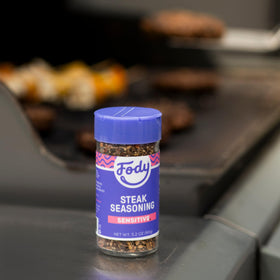 Fody Steak Seasoning sprinkled onto vegetables for a flavorful grilled dinner