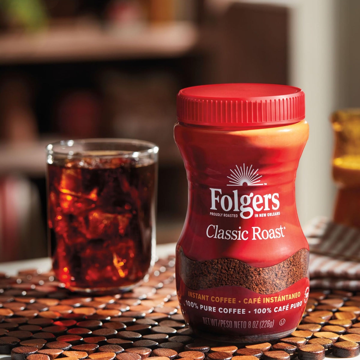 Folgers Classic Roast instant coffee being prepared in hot milk for latte.
