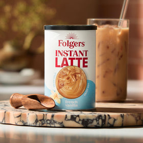 Folgers French Vanilla latte mix stirred into cold liquid for iced latte.
