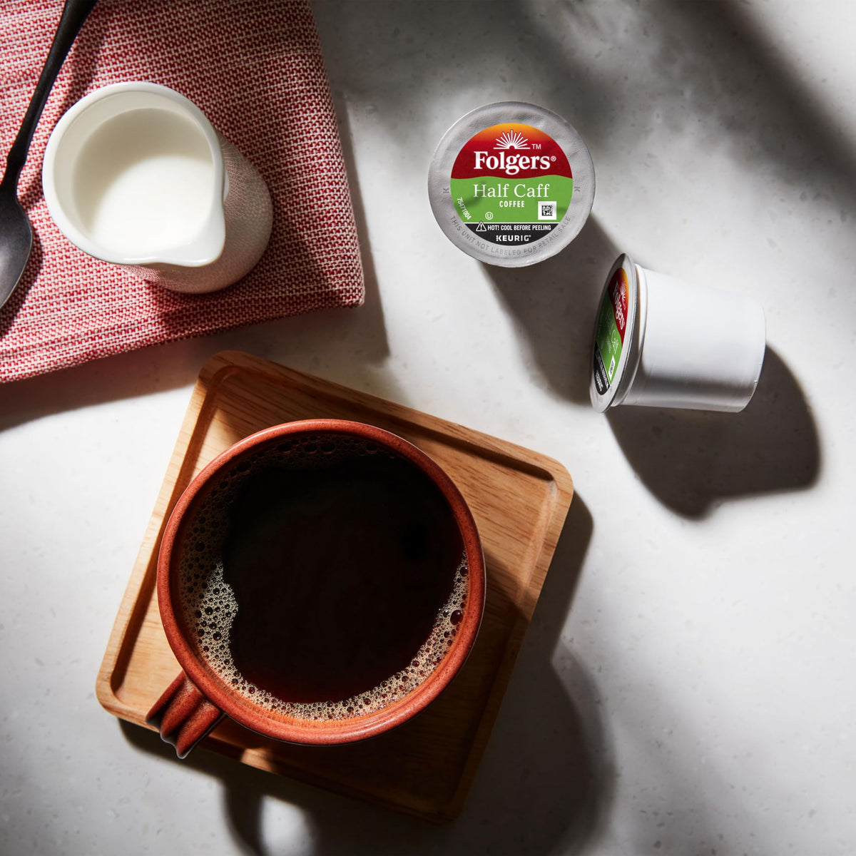 Folgers Half Caff medium roast delivers smooth, balanced flavor in a cup