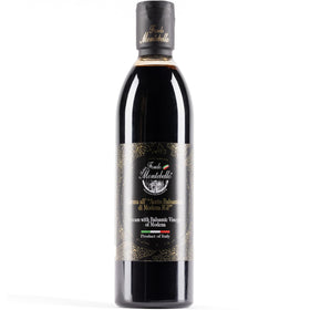 Fondo Montebello aged balsamic glaze bottle pouring a glossy salad topping