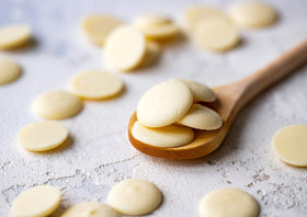 Food to Live cacao butter wafers melted pour showing silky texture for baking.