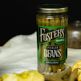 Foster's pickled green beans on an appetizer board ideal for gatherings.