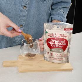 Stirring a cup of Four Sigmatic Original Mushroom Coffee for a smooth mix
