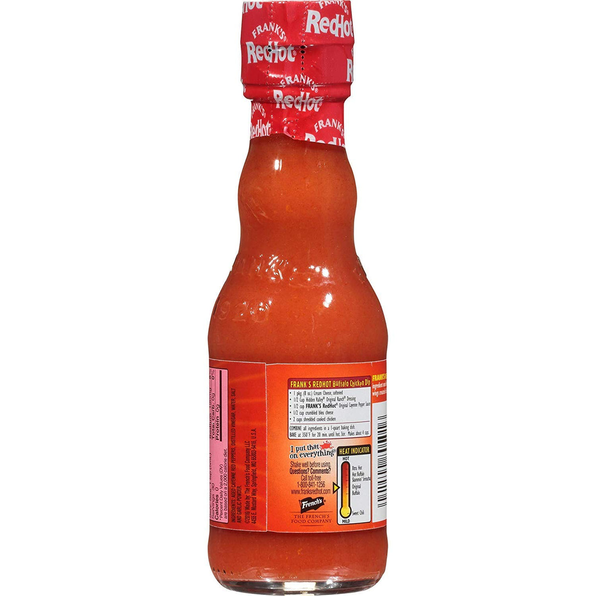 Closeup of Frank's Red Hot Cayenne Sauce glass bottle highlighting vivid color and texture.