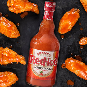 Kitchen counter setup with Frank's RedHot Original Cayenne Sauce and bowls