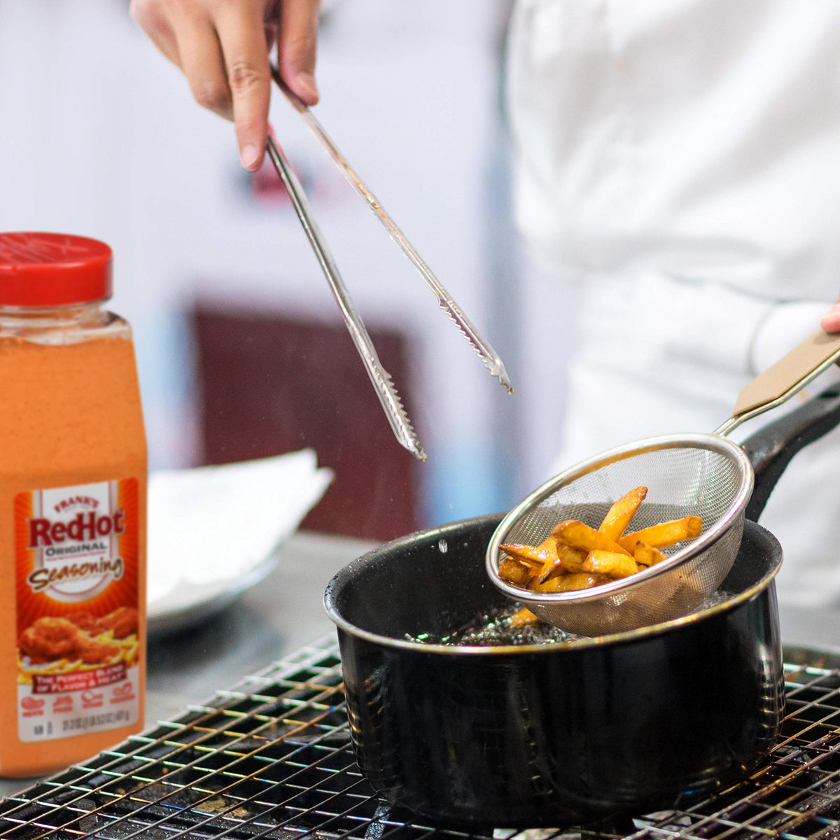 Franks RedHot Original Seasoning shaker next to burgers elevates taste.