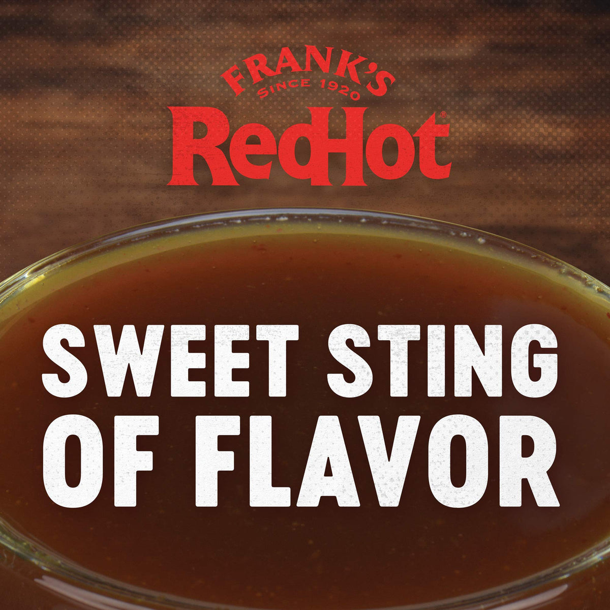 One-gallon Frank's Stingin' Honey Garlic bulk bottle on prep line