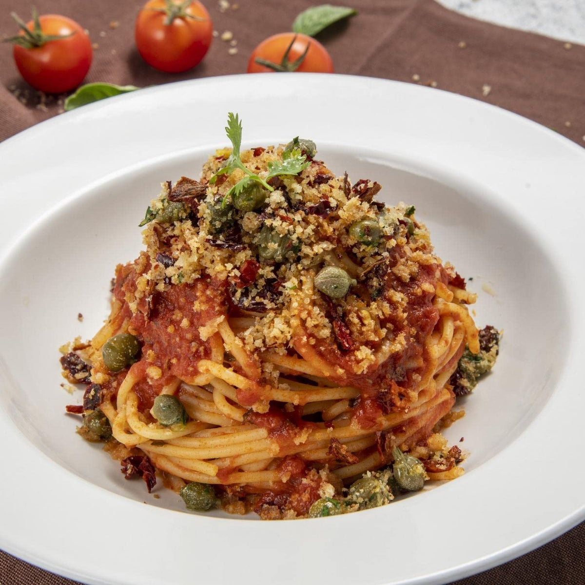 FRATELLI D'AMICO pasta puttanesca dish: assertive flavor with olive oil and tomatoes.