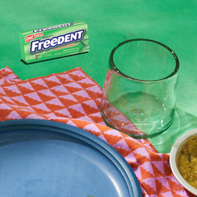 Twelve-pack display of Freedent gum for everyday use.