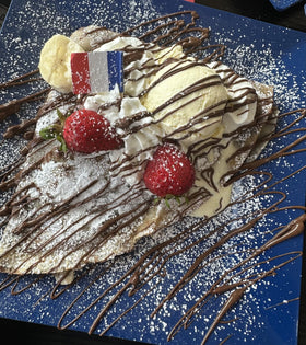 French Creperie whisking water into the mix for rapid batter.