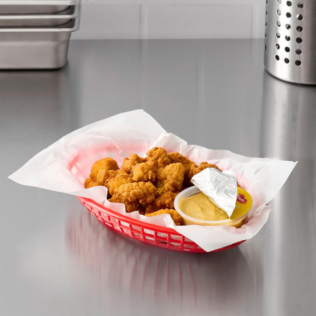 French's Honey Mustard dip cup beside chicken tenders for dipping.