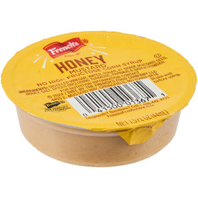 Close-up of French's Honey Mustard dip cup with label, premium packaging.