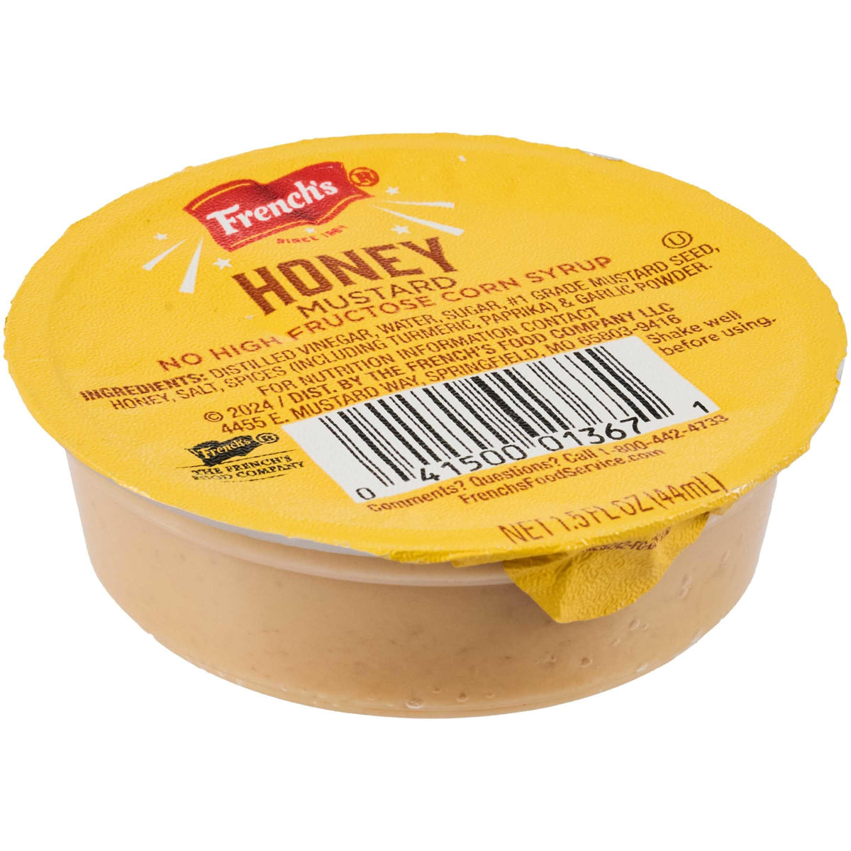 Close-up of French's Honey Mustard dip cup with label, premium packaging.