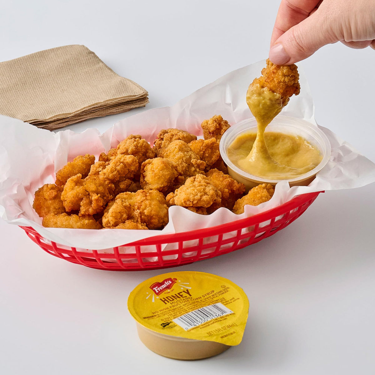 Takeout-ready French's Honey Mustard dip cups ready for orders.