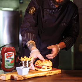 French's Tomato Ketchup topping a burger on a savory sandwich.