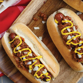 Burger with creamy yellow mustard drizzle from French's bottle