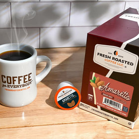 Fresh Roasted Coffee Amaretto pods brew-ready on the counter.