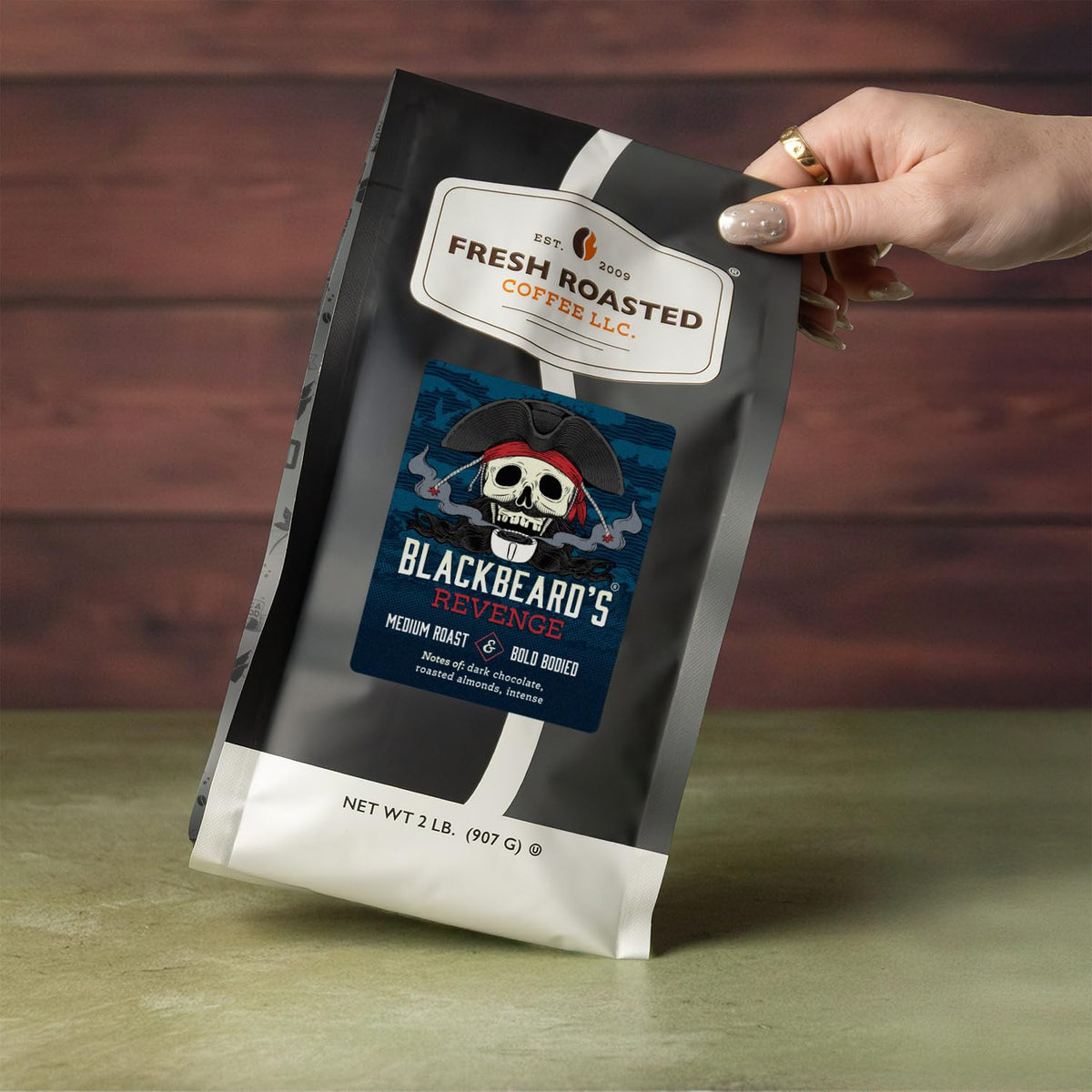 Fresh Roasted Coffee Blackbeard's Revenge whole beans close-up, hinting at bold body and aroma.
