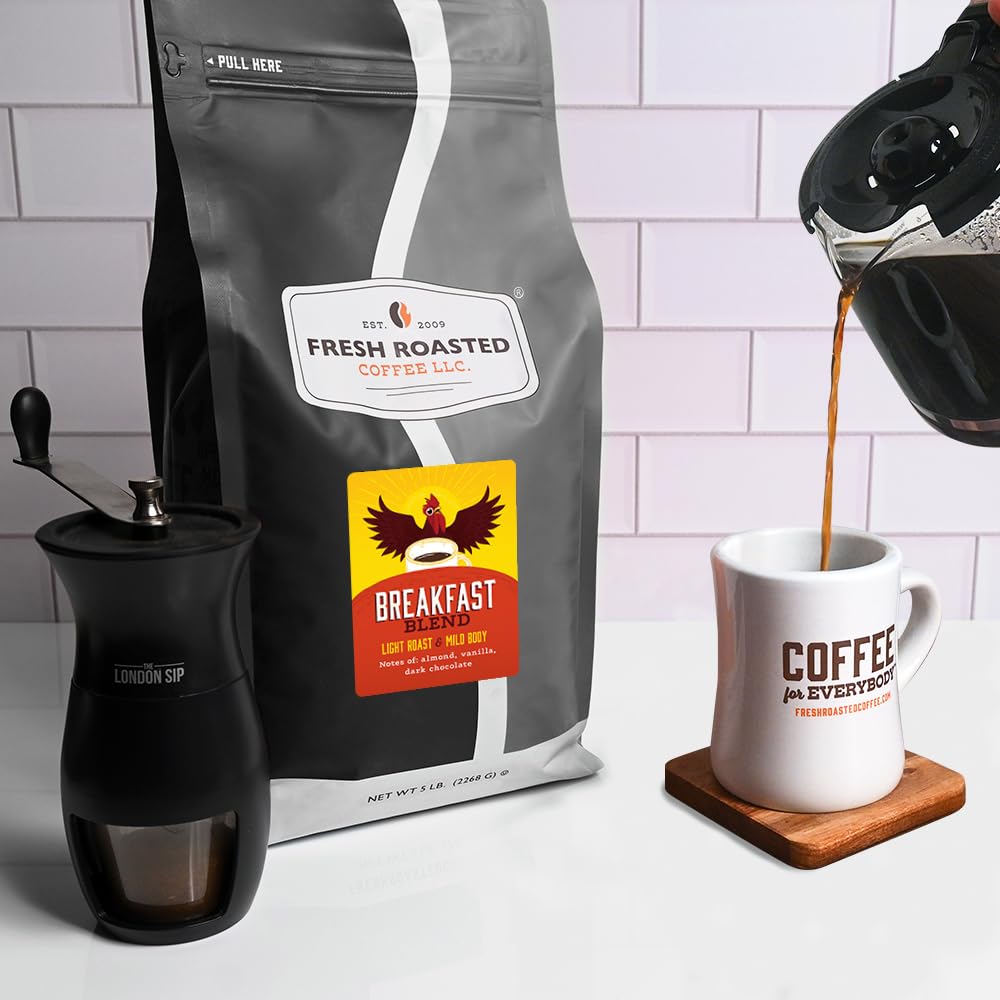 Fresh Roasted Coffee Breakfast Blend coffee beans in a grinder.