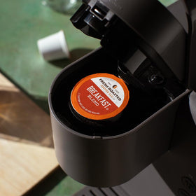 Fresh Roasted Coffee Breakfast Blend pods closeup highlighting light roast and nutty aroma.