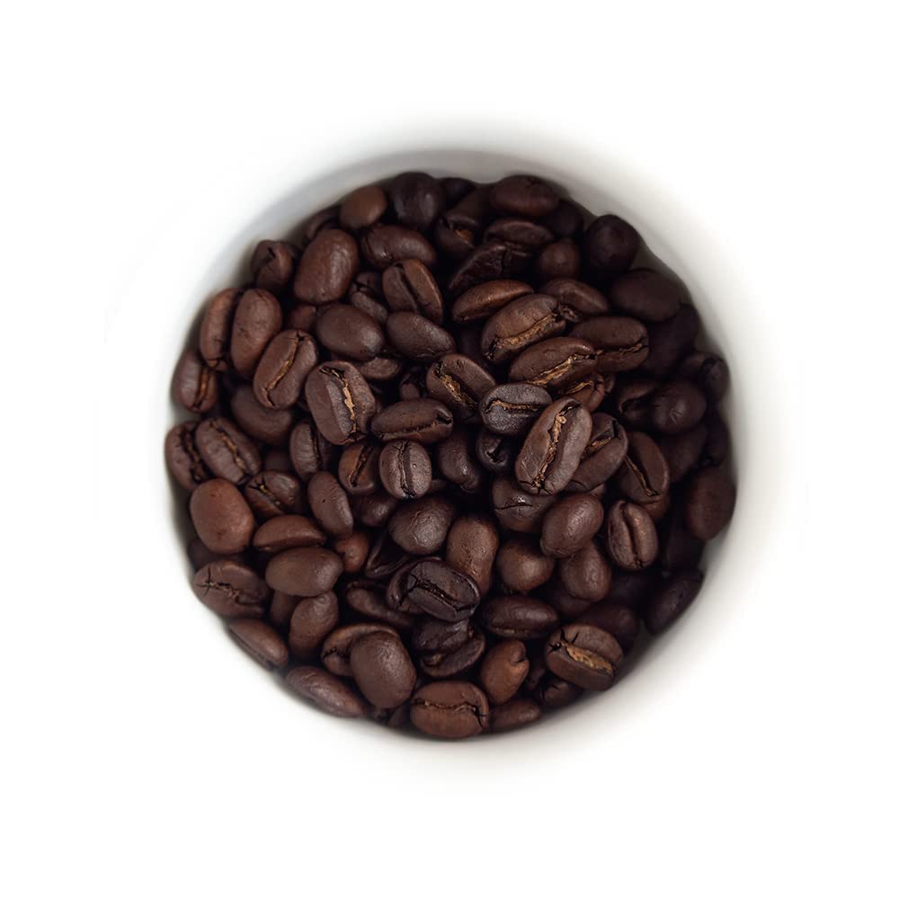 Fresh Roasted Coffee dark Sumatra Mandheling whole beans on a wooden surface ready to grind