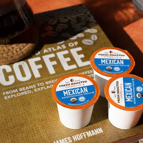 Fresh Roasted Coffee decaf cup with steam highlights the smooth medium roast.