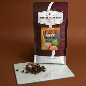 Fresh Roasted Coffee decaf hazelnut bag label close-up emphasizing flavor notes.