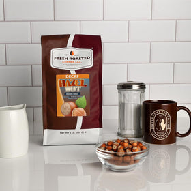 Fresh Roasted Coffee decaf hazelnut beans close-up highlighting aroma.