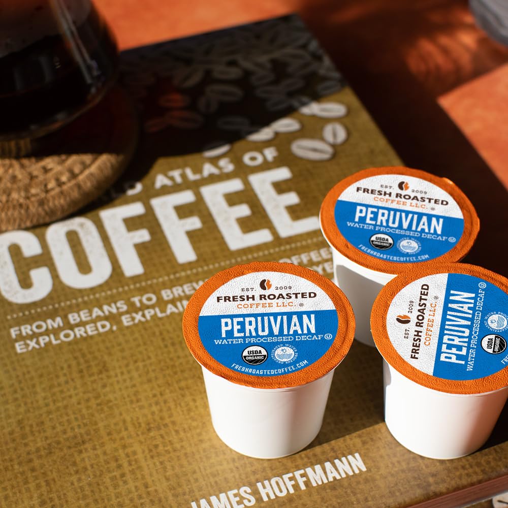 Steaming mug next to decaf pods, showcasing smooth brew.