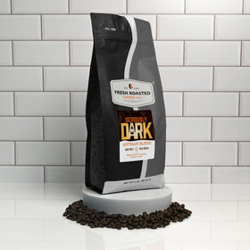 Fresh Roasted Coffee Seriously Dark Artisan Blend ground coffee on spoon, ready for espresso.