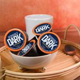 Sustainable packaging with recyclable cup and compostable grounds by Fresh Roasted Coffee.