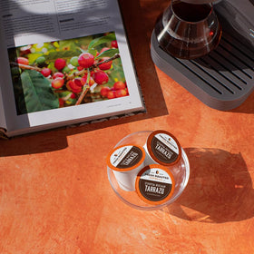 Fresh Roasted Coffee Tarrazu packaging close-up, BPA-free cup highlighted