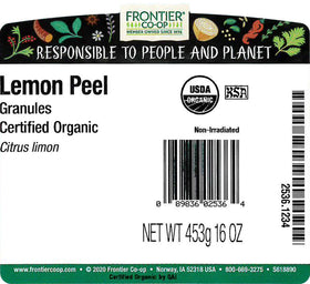 Pouring lemon peel granules from a spoon, delivering bright citrus flavor.
