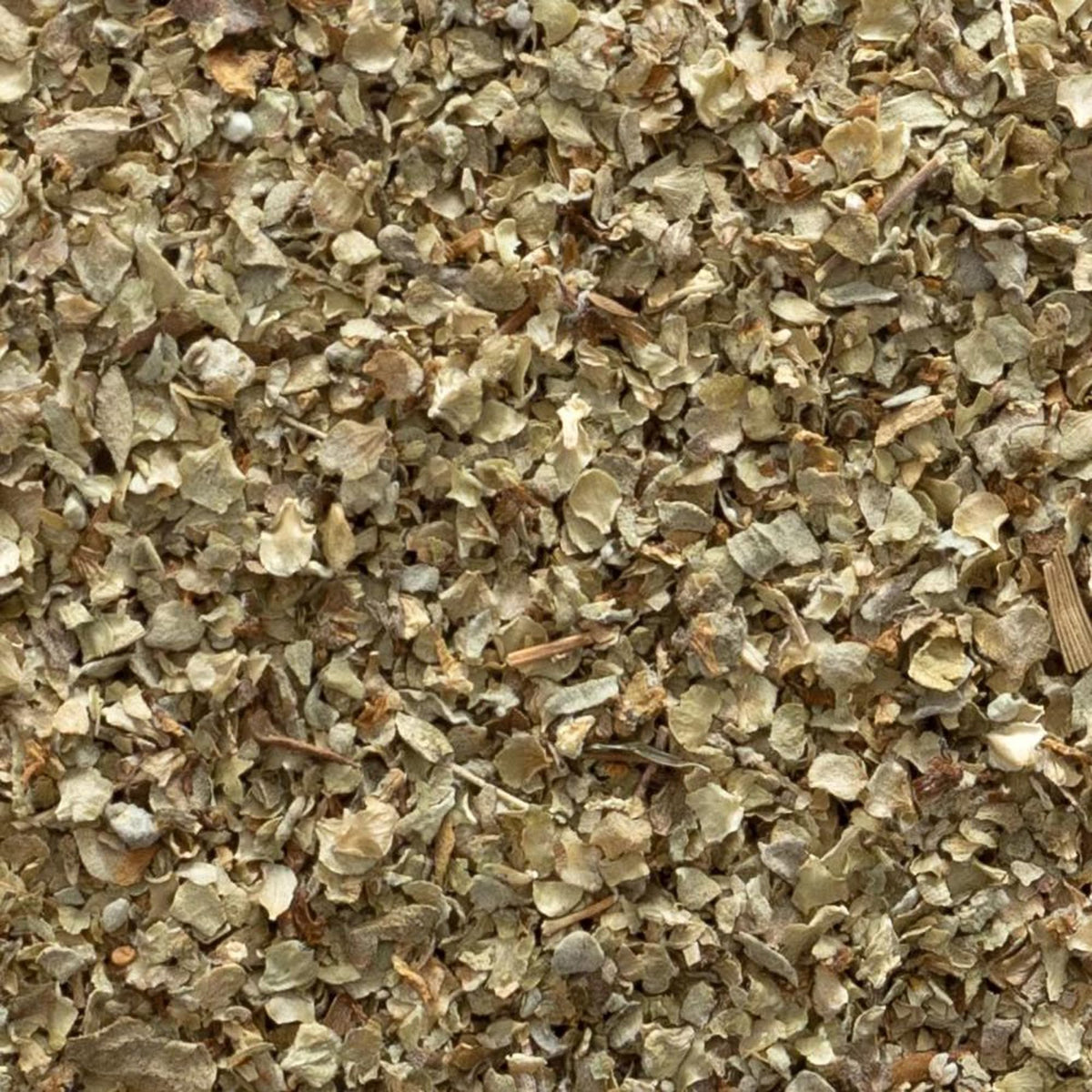 Frontier Co-op marjoram leaf being sprinkled into a pan for flavor.