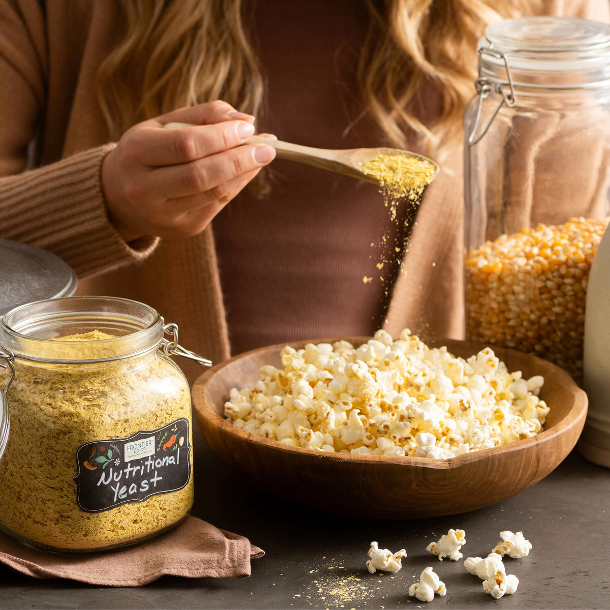 Frontier Co-op Nutritional Yeast Mini Flakes bottle closeup, highlighting non-irradiated, B-vitamin rich powder.