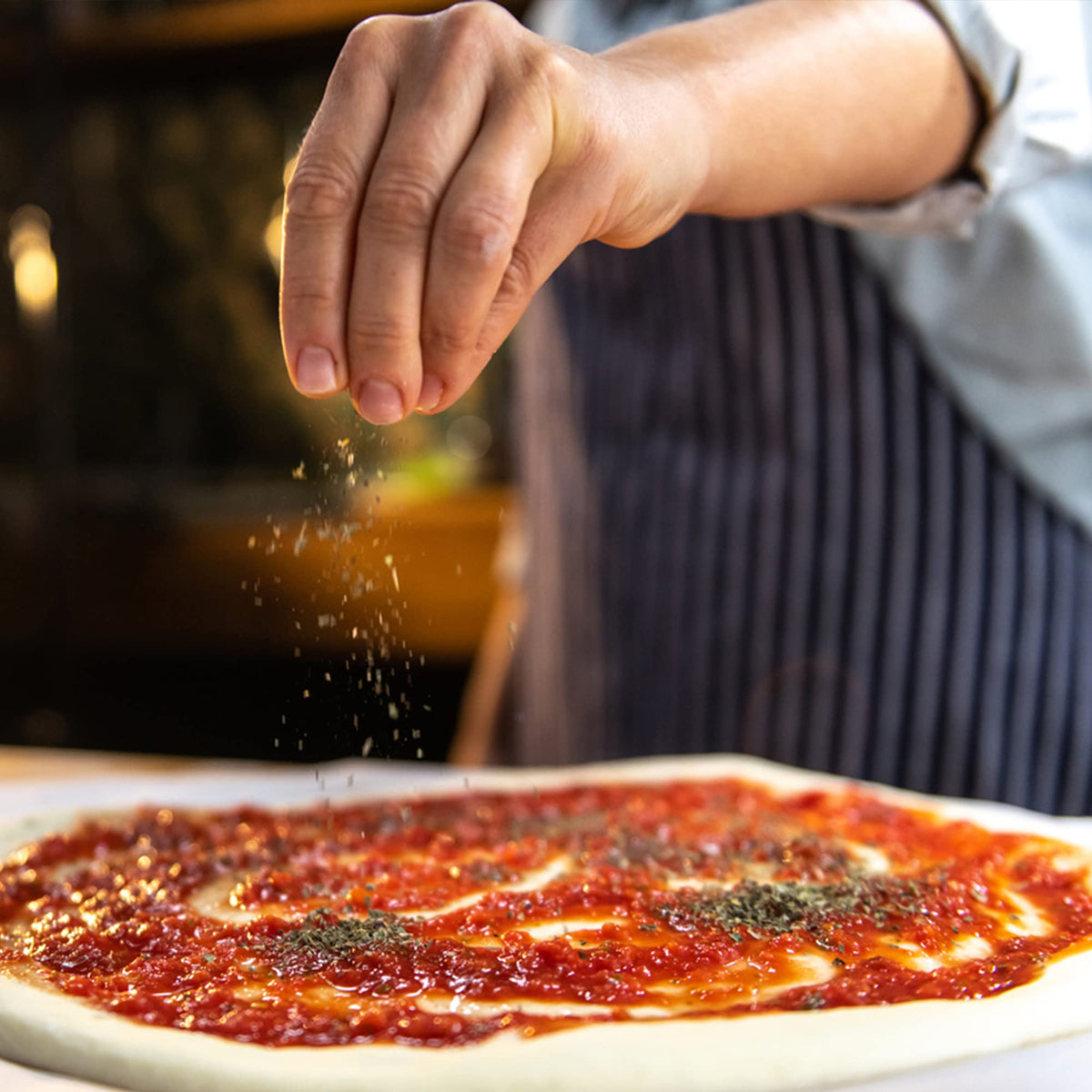 Pizza topped with Frontier Co-op seasoning for deeper crust flavor.