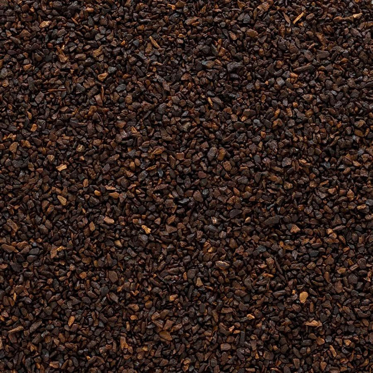 Close-up of roasted chicory root granules showing caramelized, nutty texture