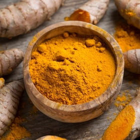 Frontier Co-op turmeric powder with measuring scoop enables precise seasoning in recipes.