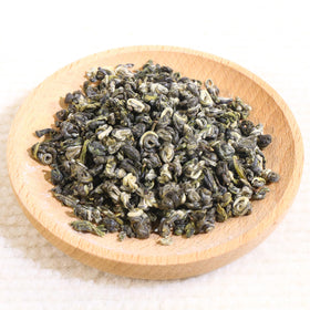 FullChea Bi Luo Chun brewed tea in cup with bright color and inviting scent.