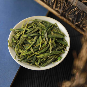 FullChea Dragonwell tea in cup reveals bright flavor.