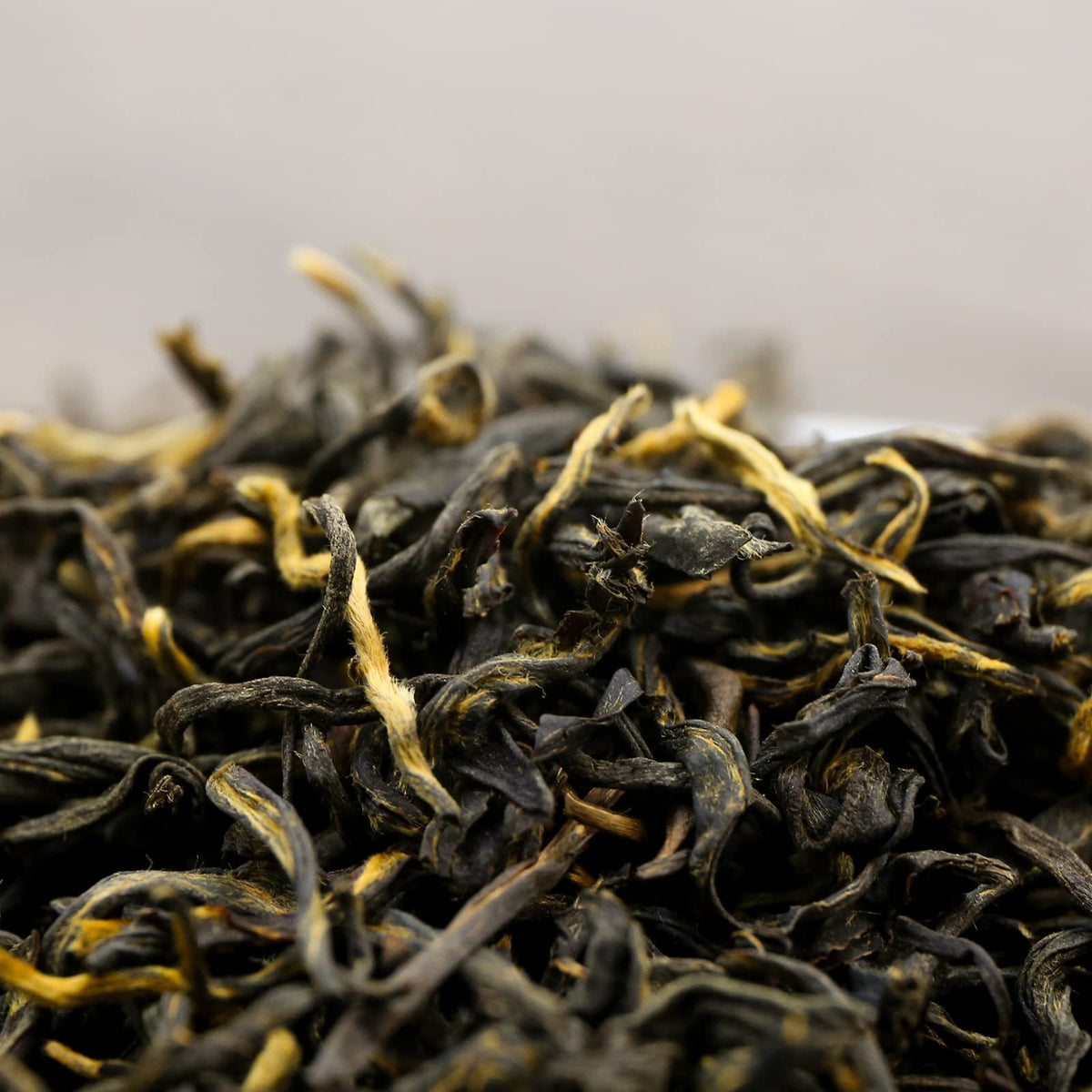 FullChea Golden Monkey Tea dry leaves close-up reveal gold tips and aromatic potential.