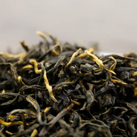 FullChea Golden Monkey Tea dry leaves close-up reveal gold tips and aromatic potential.