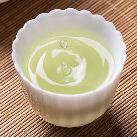 FullChea Mao Feng dry tea closeup reveals floral notes and a gentle, inviting aroma.